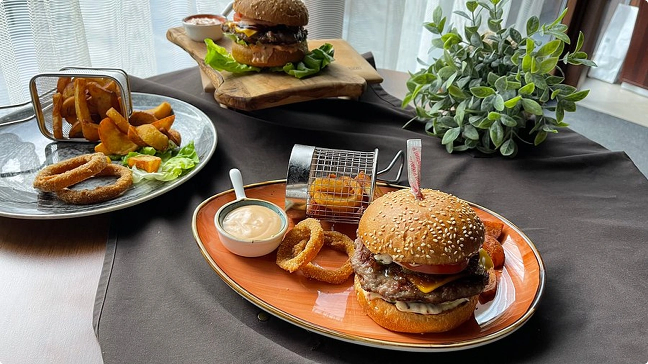 Burgers, fries, fired onion served on plate